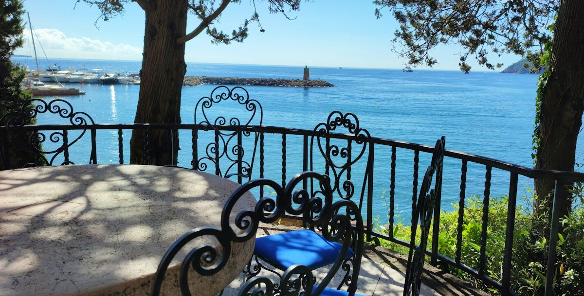 Mesa y sillas en una terraza frente al mar